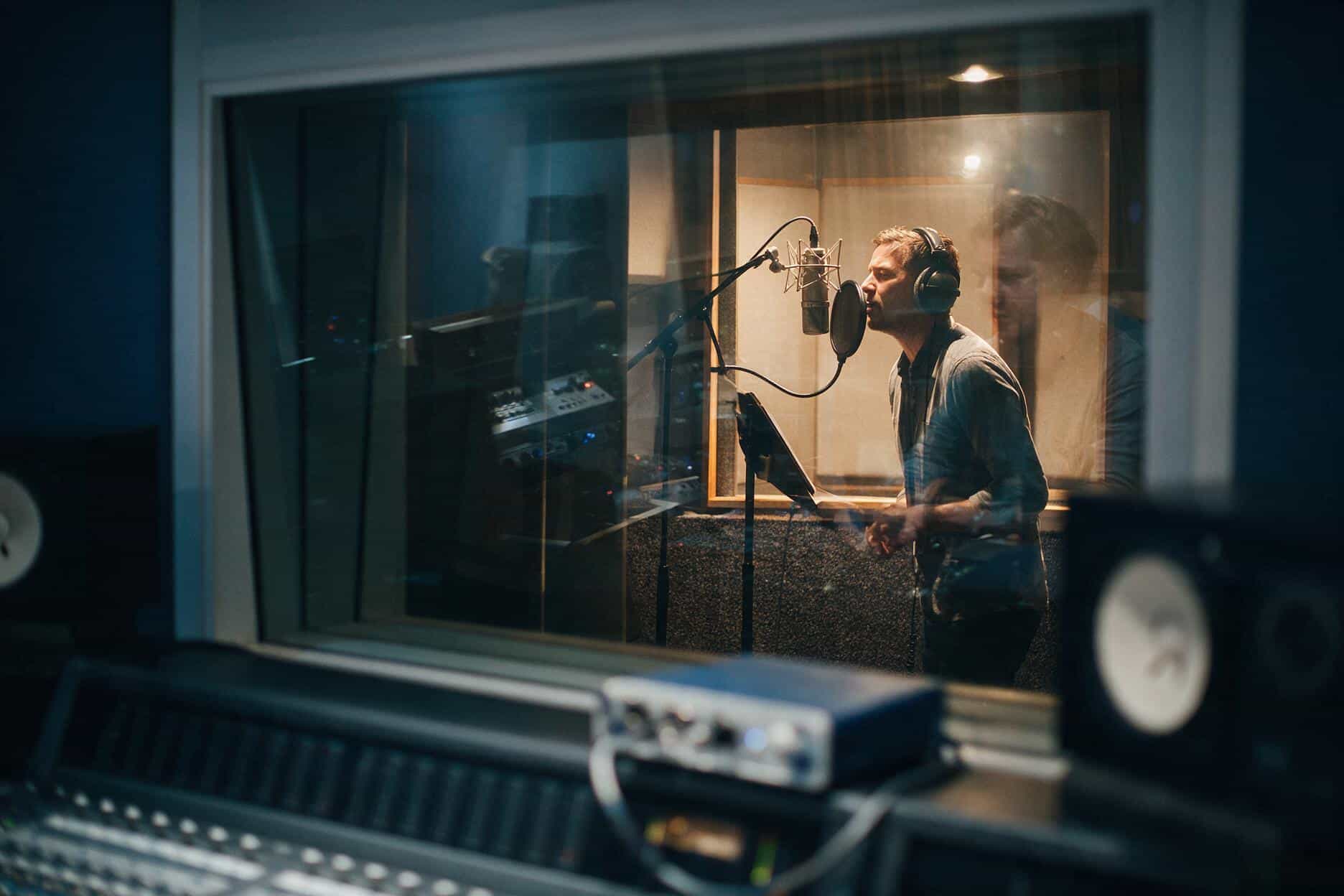 Voice actor at the microphone during a Malagasy recording session
