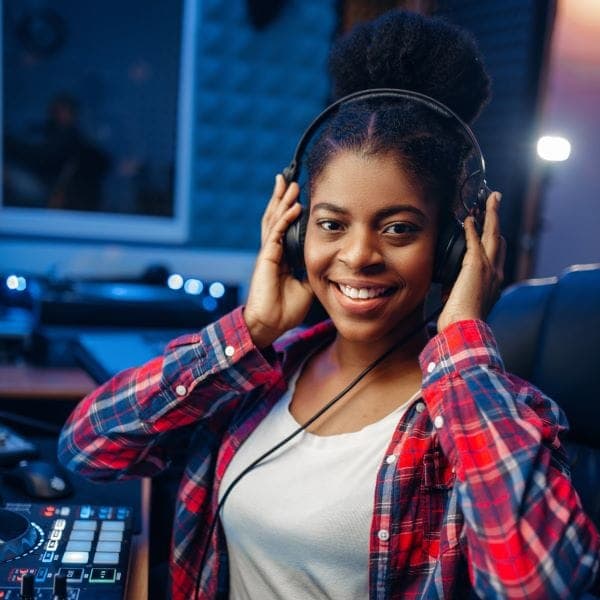 Female voice actor smiling with headphones in studio