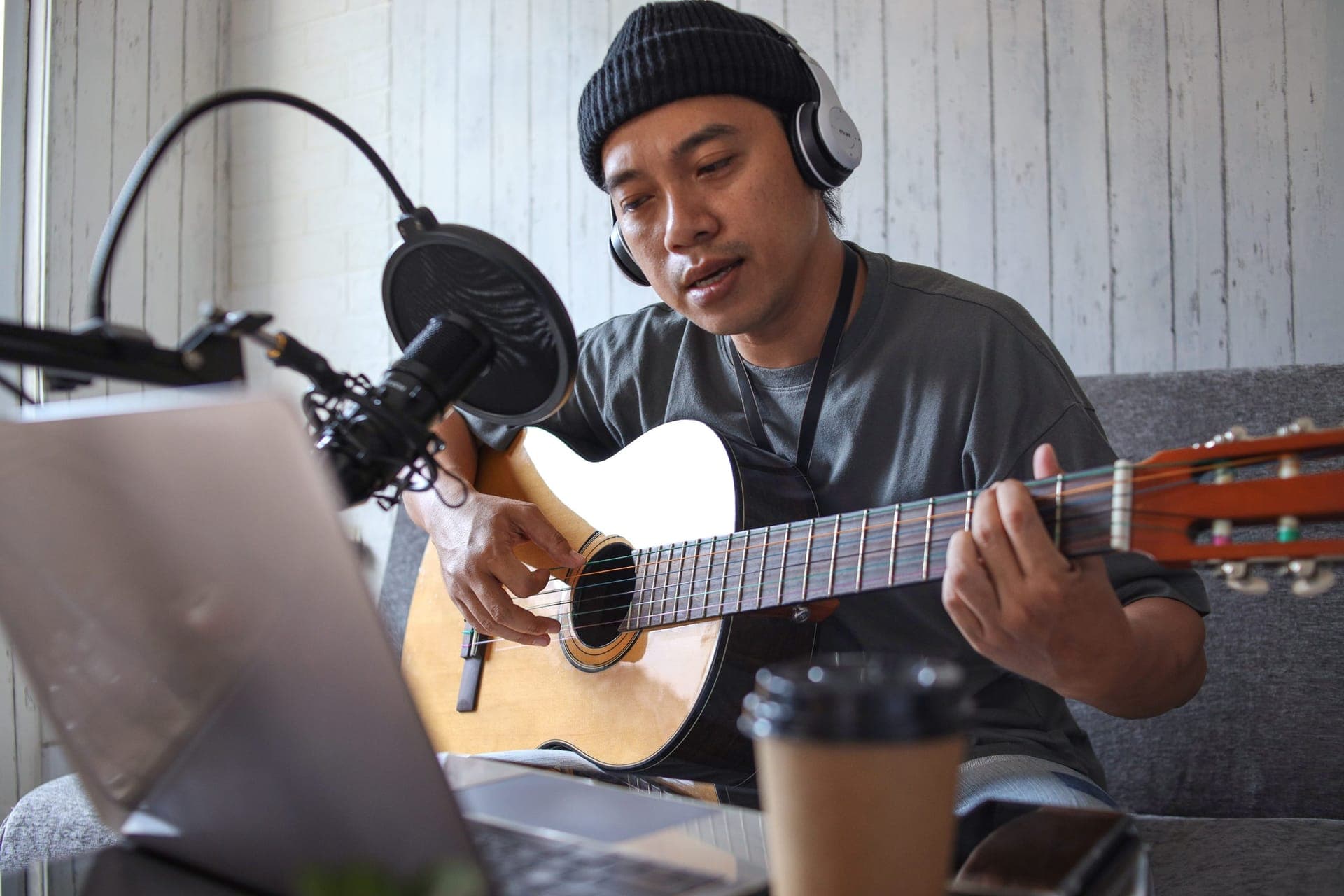 Asian voice artist recording a podcast in studio