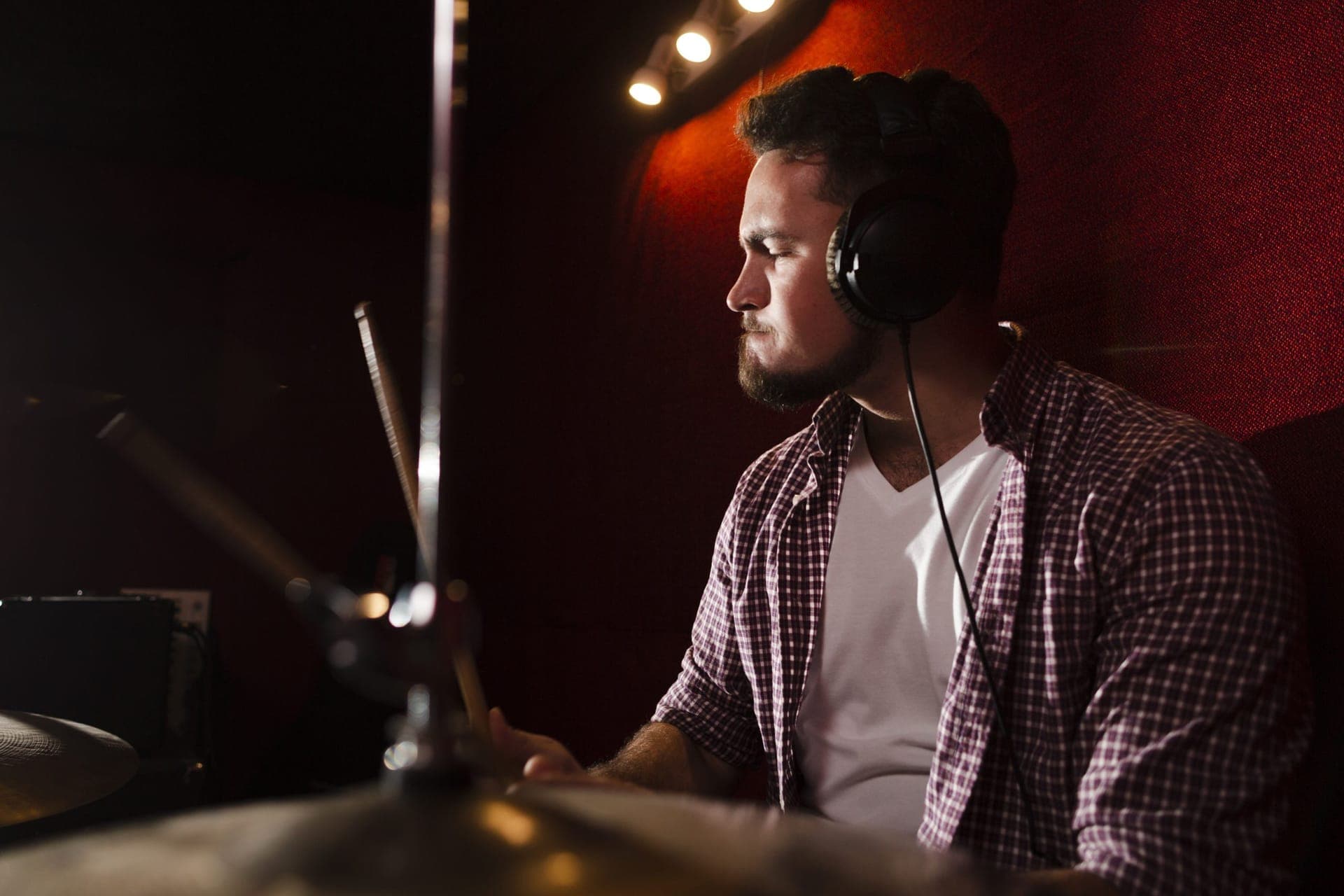 Man playing drums wearing headphones
