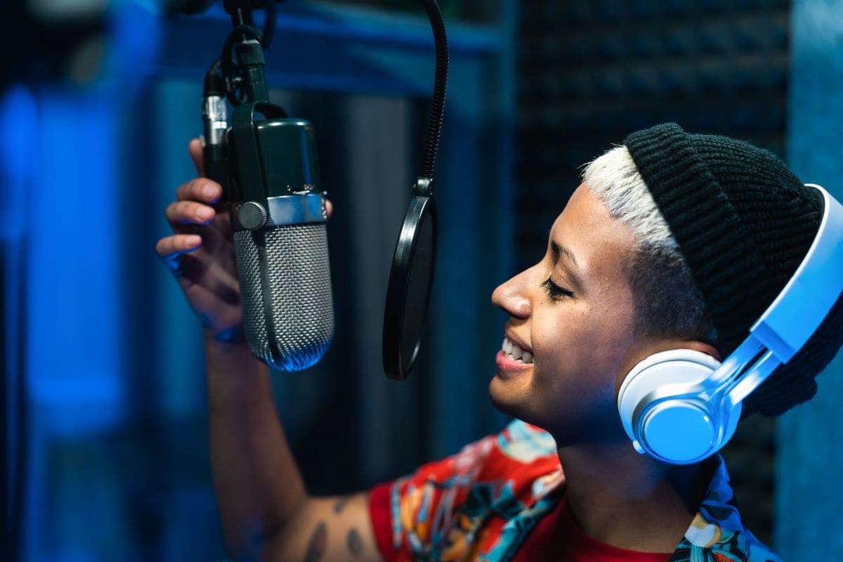 Female singer recording at a studio microphone