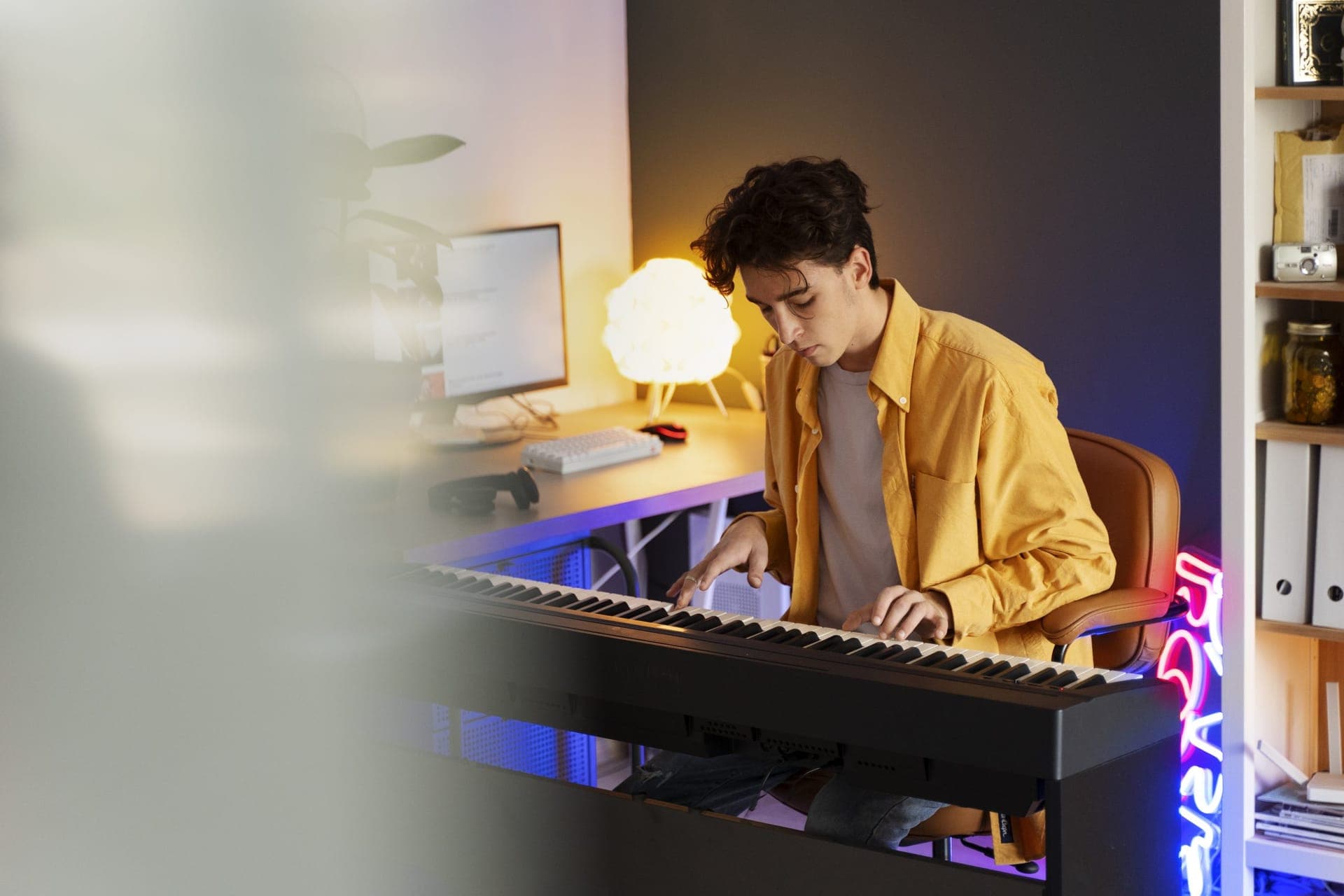 Teenager playing piano at home