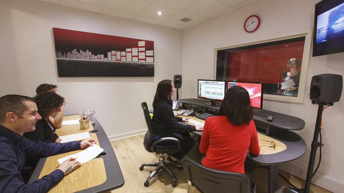 Clients directing a voice over session from the control room at GoLocalise's London studio