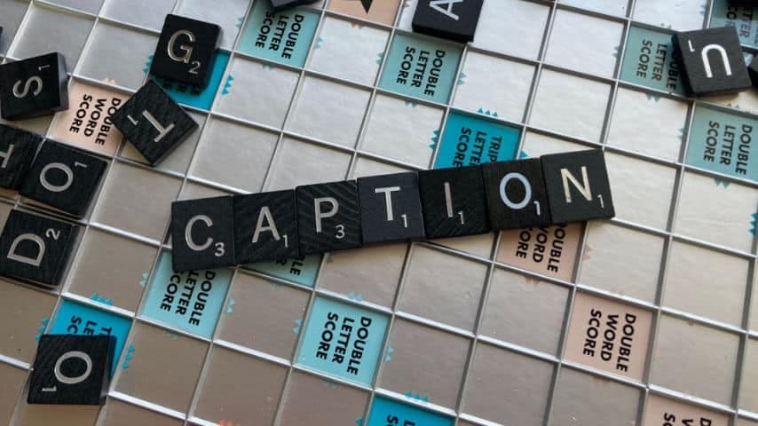 Scrabble board with the word CAPTION in the middle