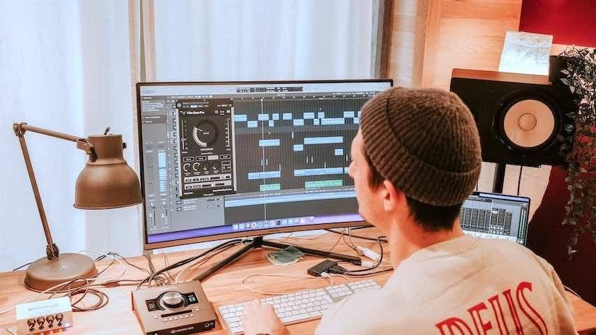 Home recording studio. Photo of a man in his home studio. Unsplash license: https://unsplash.com/photos/J1J6JPKllNY