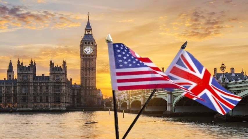 A British and an American flag in front of Big Ben in London