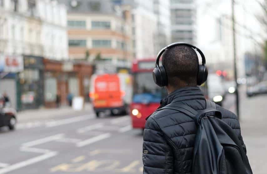 Photo of a man wearing headphones to illustrate the article “PFH Meaning for Audiobooks and Voice Over Work”. Unsplash license: https://unsplash.com/photos/bAFiBDMeiVI