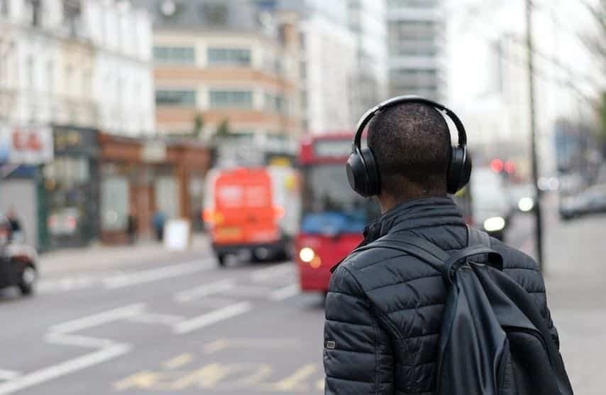 Photo of a man wearing headphones to illustrate the article “PFH Meaning for Audiobooks and Voice Over Work”. Unsplash license: https://unsplash.com/photos/bAFiBDMeiVI