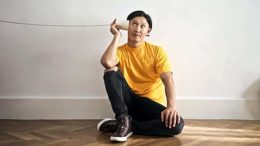 Phonetic Transcription. Image of a young man listening to paper cup phone to illustrate the article Phonetic Transcription: Understanding Language Sounds. Photo by Andrea Piacquadio.