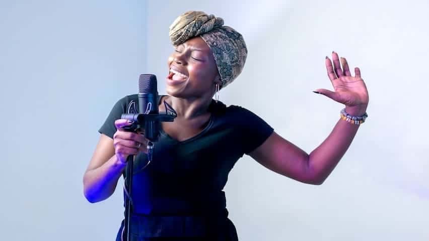 Preparing Your Voice to Sing. Image used to illustrate the article Preparing Your Voice to Sing: Tips and Techniques. Image of a woman singing in music studio. Pexels licence: https://www.pexels.com/photo/photo-of-woman-singing-in-music-studio-2531728/