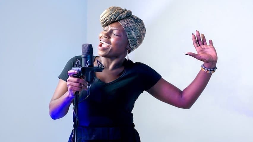 Preparing Your Voice to Sing. Image used to illustrate the article Preparing Your Voice to Sing: Tips and Techniques. Image of a woman singing in music studio. Pexels licence: https://www.pexels.com/photo/photo-of-woman-singing-in-music-studio-2531728/