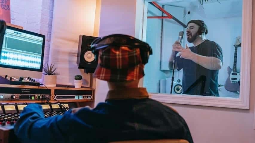 The Scope of Voice-Over Jobs for Beginners. Sound engineer and voice over actor in a recording session. Pexels license: https://www.pexels.com/photo/two-men-in-a-recording-studio-with-sound-equipment-8132970/