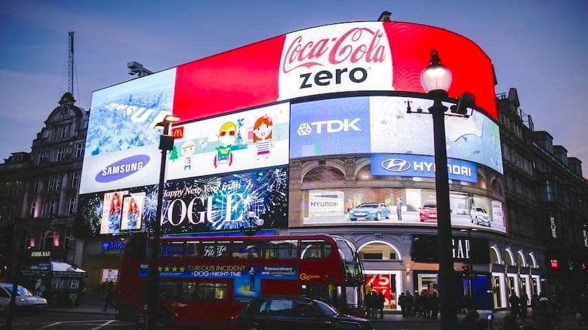 Commercial Voice Over Jobs. Image of Picadilly Circus in London shoring a billboard with commercial brands. This image is used to illustrate the article "Commercial Voice Over Jobs: Navigating the Industry." Pexels license: https://www.pexels.com/photo/photo-of-commercial-district-during-dawn-34639/