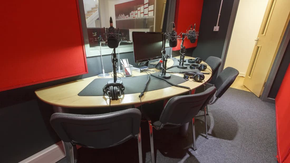 Red Studio booth set up with microphones for a group session