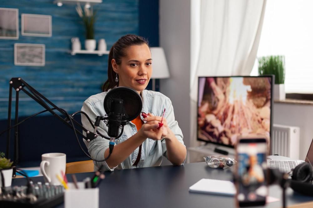 An editor working at a desk with a microphone and monitor, illustrating practical video editing