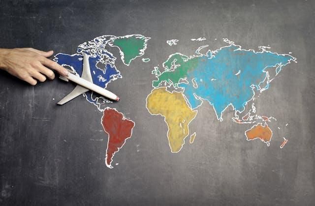 A world map with a model aeroplane, illustrating adapting video content for global audiences