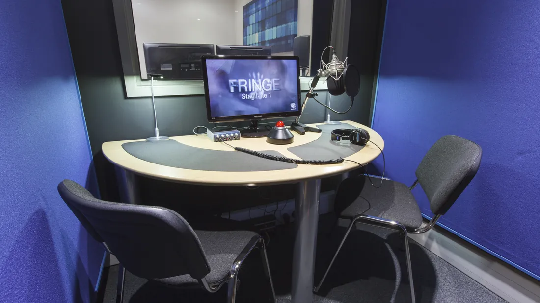 Acoustically treated voice over booth interior