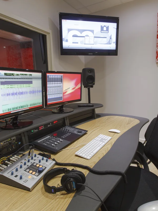 Studio control desk with mixing console and editing screens