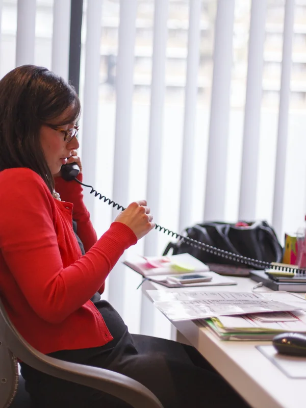 GoLocalise project manager taking a client call at her desk