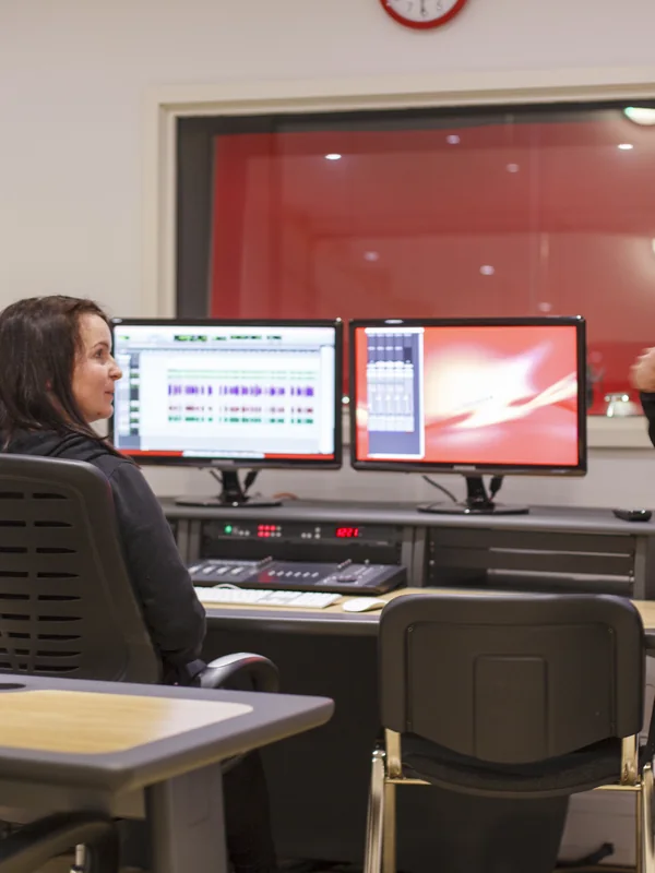 Engineer at the Red Studio control desk with live Pro Tools screens